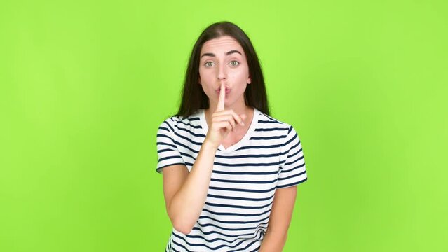 Young brunette woman doing silence gesture over isolated background. Green screen chroma key