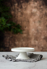 Empty White Cake Stand on the background of an old wall