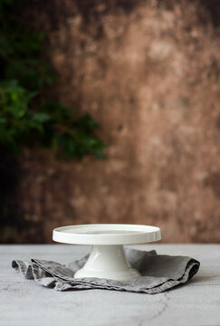 Empty White Cake Stand on the background of an old wall