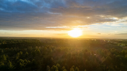 Fototapeta premium Beautiful sunset over a river with green bushes and color rich sky. High quality photo
