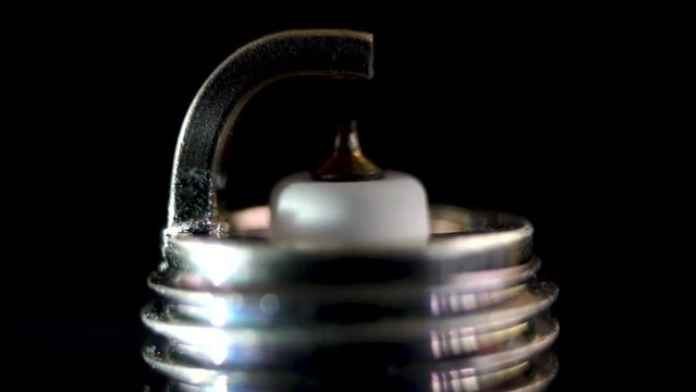 Close-up. Automotive spark plug with thin iridium electrode