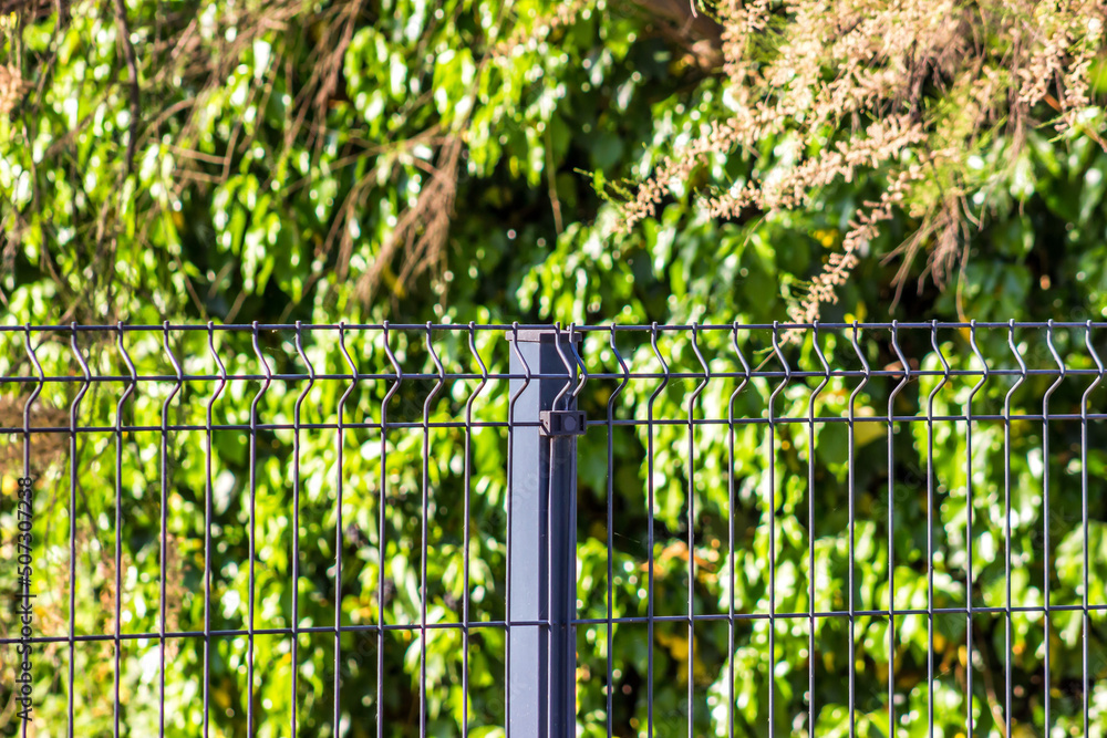 Wall mural steel grating fence made with wire.