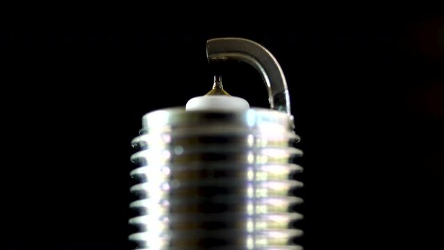 Close-up. Automotive spark plug with thin iridium electrode