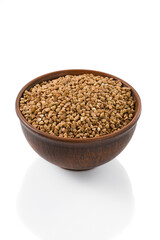 buckwheat seeds in a bowl on a white background, isolated