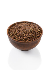 lentil seeds in a bowl on a white background, isolated