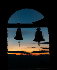 Orthodox monastery bells in sunset in Greece