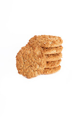 Oatmeal, fig, hazelnut, pistachio and sesame cookies on a white background. Enjoyable snack.