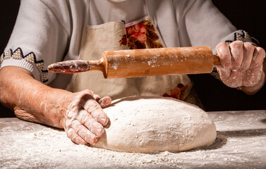 Hands of granny kneads dough. 80 years old woman hands kneading dough. homemade baking. Pastry and cookery