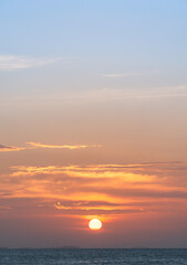 Sunset sky over sea vertical in the evening