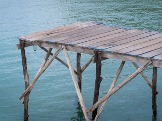 Fisherman's wooden log terrace leading into the sea. - 507310246