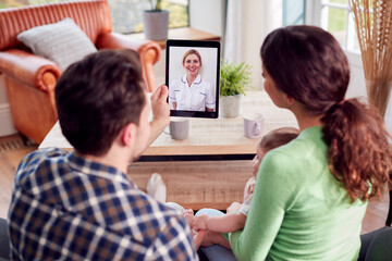 Obraz premium Transgender Family With Baby Having Virtual Postnatal Video Call With Health Worker At Home