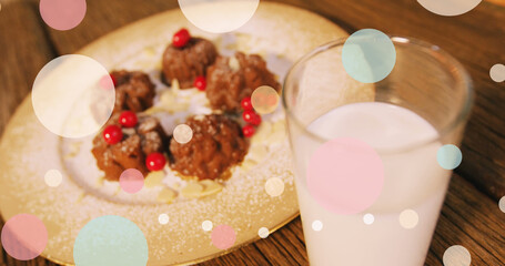 Image of spots over milk and cookies at christmas