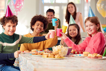 Portrait Of Girl With Parents And Friends At Home Celebrating Birthday With Party