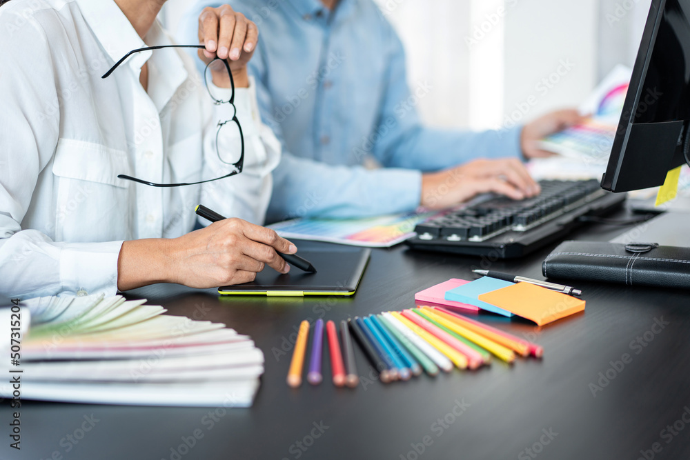 Aufkleber Team of creative graphic designer working on color swatch samples chart for selection coloring in inspiration to create new collection at workplace