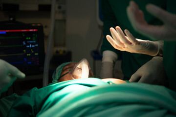 Professor of medicine in cardiology and a team of doctors in the operating room undergoing heart...