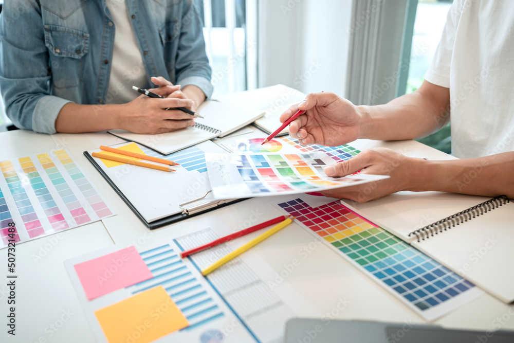 Poster Team of creative graphic designer working on color swatch samples chart for selection coloring in inspiration to create new collection at workplace