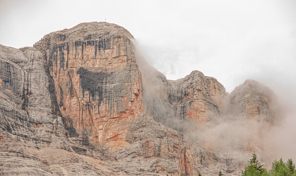 East face of Sasso di Santa Croce mountain range in the eastern Dolomites, its 900 meters vertical wall and Mount Cavallo, seen from Roda de Armentara trail to St. Croce refuge, South Tyrol, Italy
