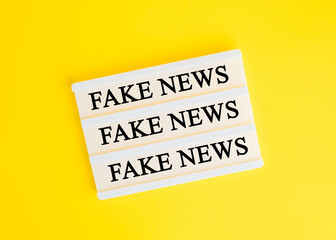 The inscription on a yellow background FAKE NEWS