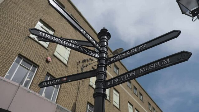 Directional arrow post leading to famous landmarks in Kingston Upon Thames, close up orbit view