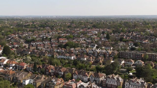 Living district of private homes in London suburbs, aerial descend view