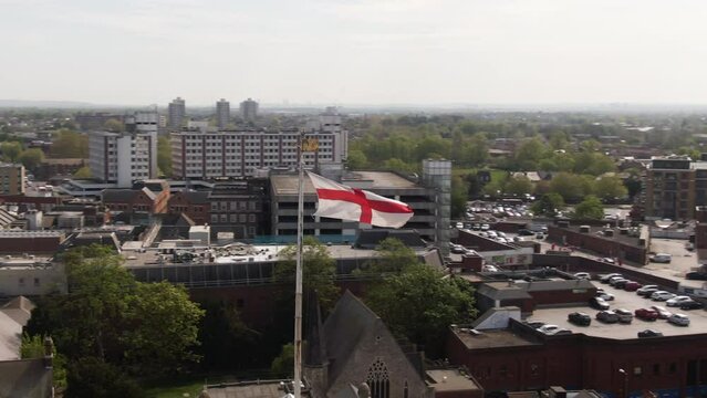 National flag of England waving with cityscape background, aerial orbit view