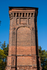 Tall old red brick tower in the park