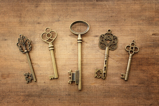 Top view image of old keys over wooden background