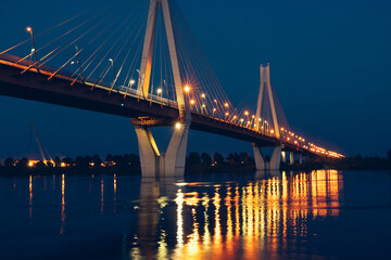 Fototapeta na wymiar night glowing bridge over the river
