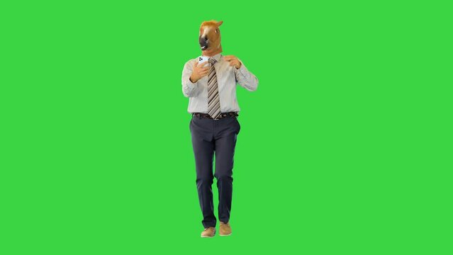 Funny office worker man in horse mask walk taking selfie photos on smartphone posing and gesturing on a Green Screen, Chroma Key.