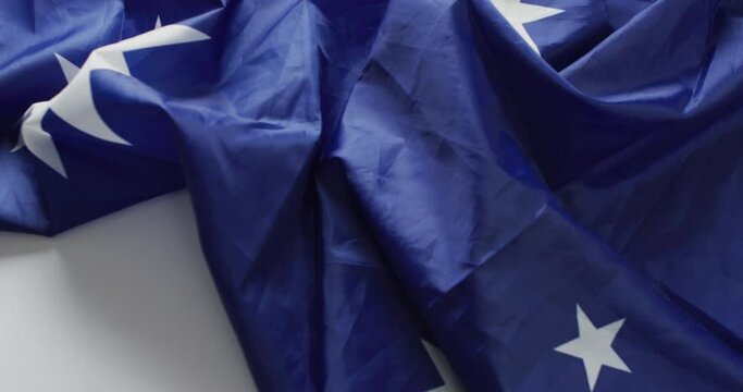 Video of creased flag of australia lying on white background