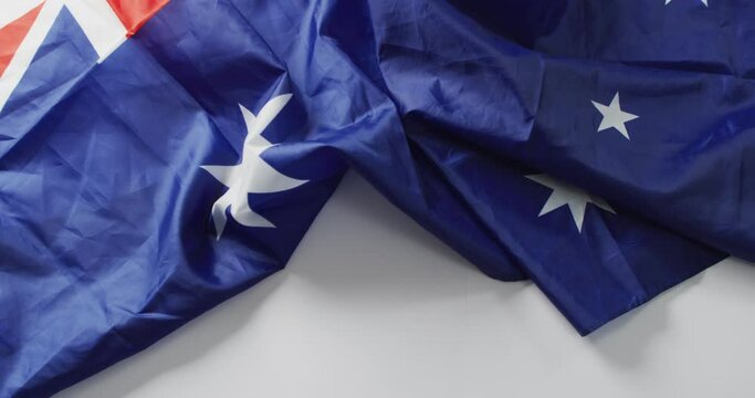 Video of creased flag of australia lying on white background