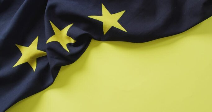 Video of creased flag of european union lying on yellow background