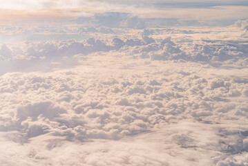 View over the clouds above Tanzania. Bright skyscape