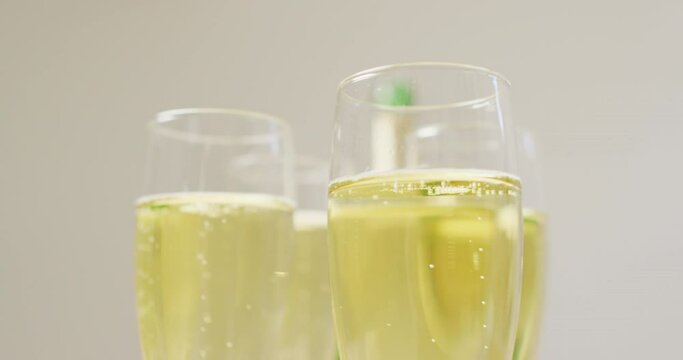 Video of champagne in glasses on beige background