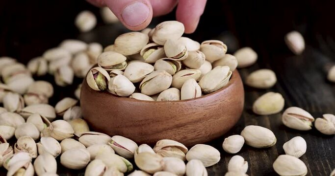 pistachio nuts in a wooden bowl