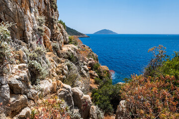 Lycian way hiking and trekking route with sea view  in Turkish Mediterranean area with rocks, mountains. Mountain landscape image taken on the Lycian way hiking trail near Kas, Turkey. 