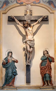 MONOPOLI, ITALY - MARCH 6, 2022: The baroque carved polychrome sculptural group of Calvary in the church Chiesa di San Antonio from year 1744.