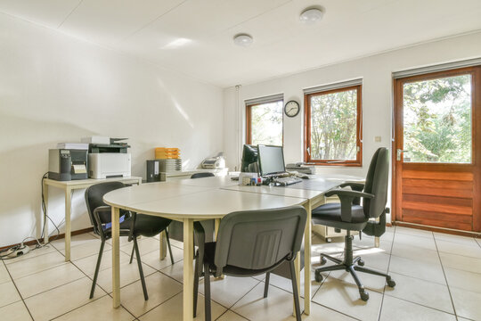 Office equipment on tables in spacious workplace