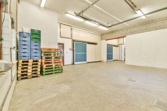 Various pallets with cardboard and plastic containers in warehouse