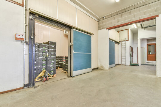 Spacious corridor of storehouse with blue metal doors