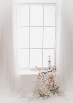 a white set up with marine decor elements in a photo session for a first communion photo session