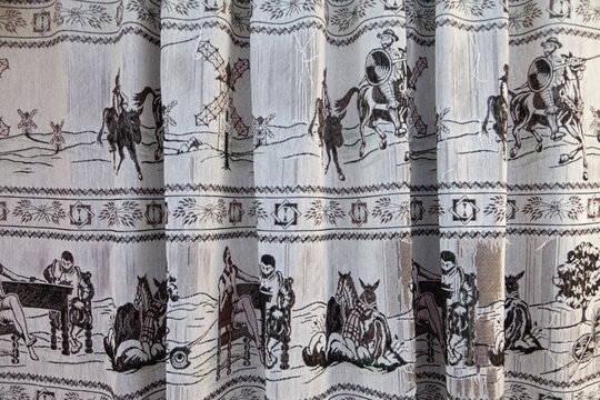 patterned curtains with drawings of Don Quixote and his squire Sancho Panza