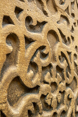 close up of a wall with arabic decorative motifs made in stone