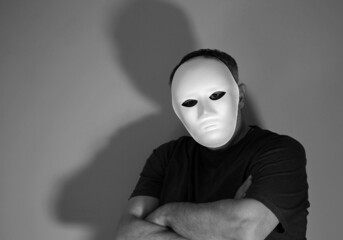 black and white photograph of a masked man
