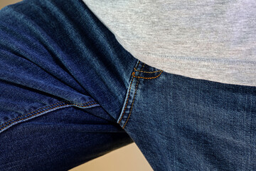 a man in blue jeans with a zipper
