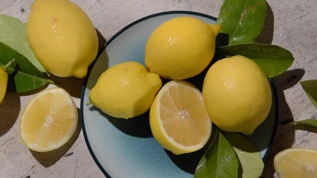 Raw fresh lemons on light wooden background. Harvest, agricultural concept, healthy organic ingredients
