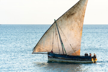 large african sailing dhow on the ocean with a distant blue horizon