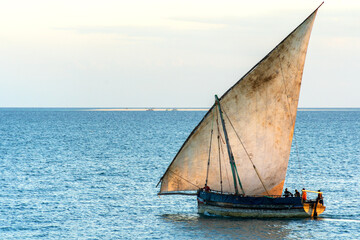 large african sailing dhow on the ocean with a distant blue horizon - obrazy, fototapety, plakaty