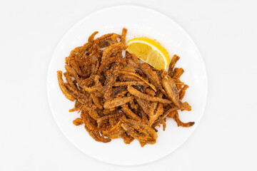 Crispy Pig Ears with Lemon on a White Plate
