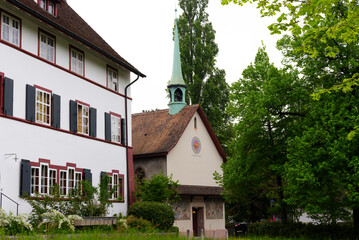 Fototapeta na wymiar Historic house with chapel at district of St. Jakob at City of Basel on a cloudy spring day. Photo taken April 27th, 2022, Basel, Switzerland.